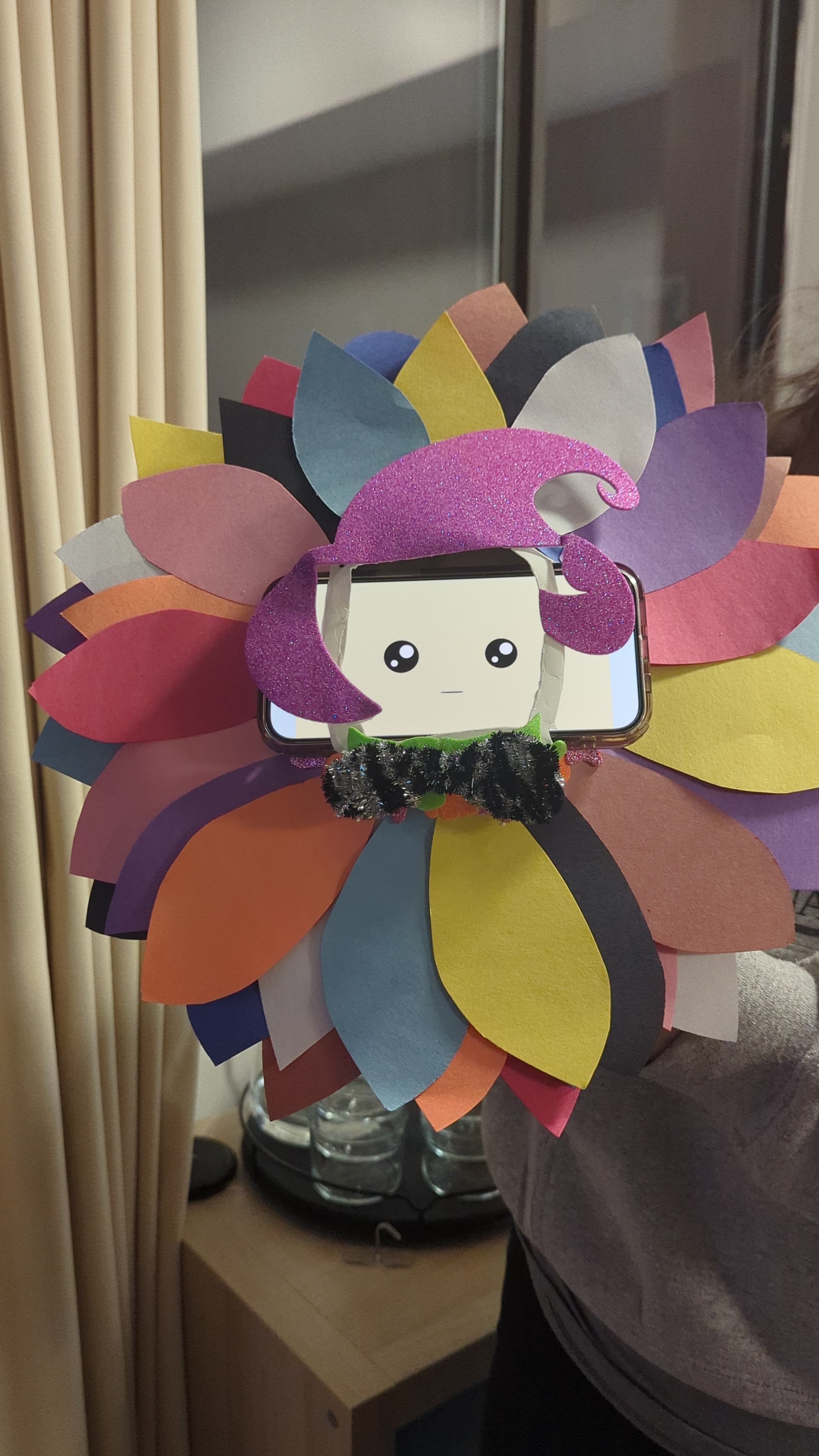 Timothy the flower robot created out of paper plate, construction paper petals, and pipe cleaners.